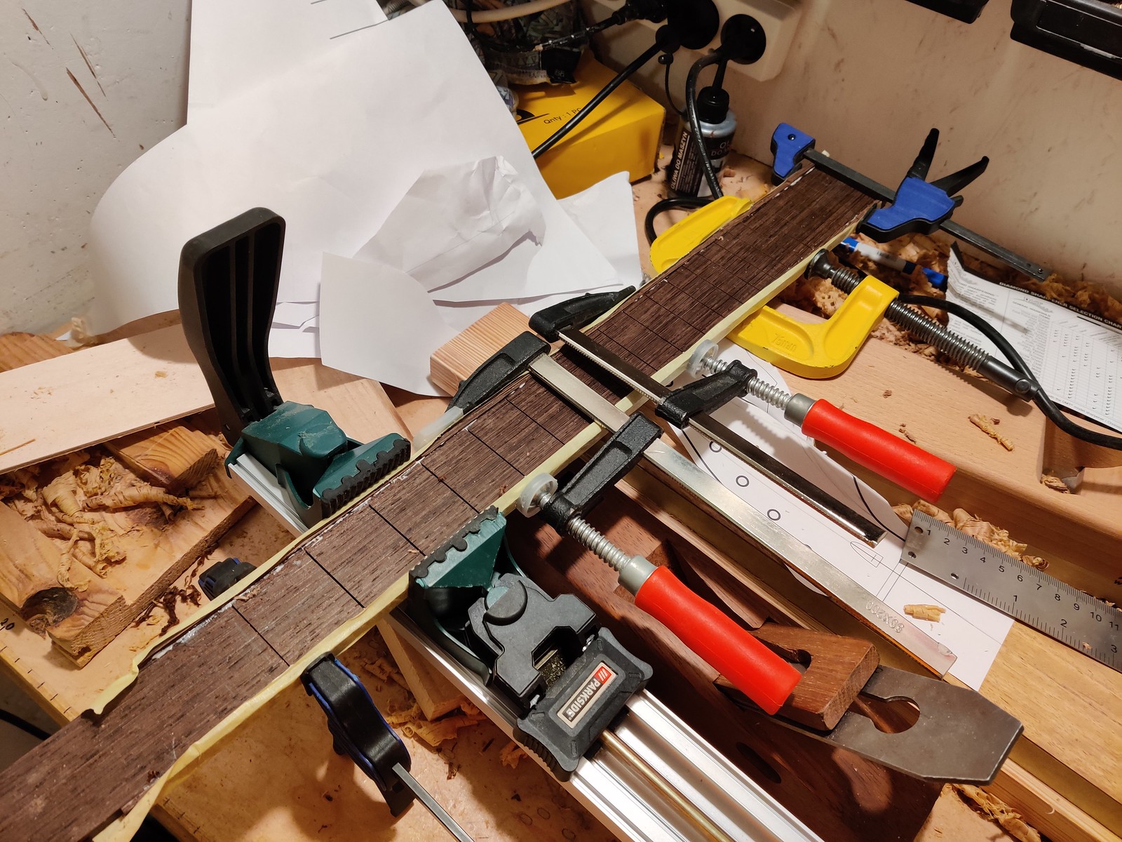 A wenge fretboard in a lot of clamps