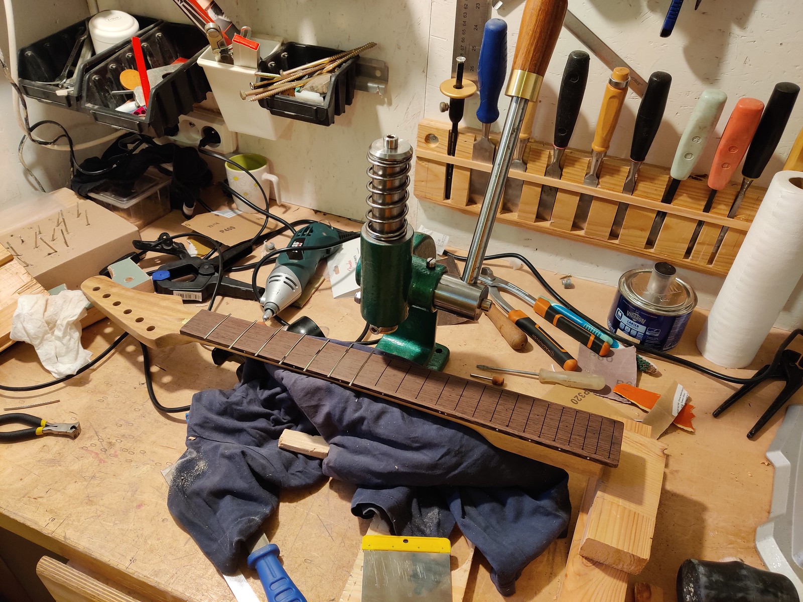 Guitar neck under a fret press