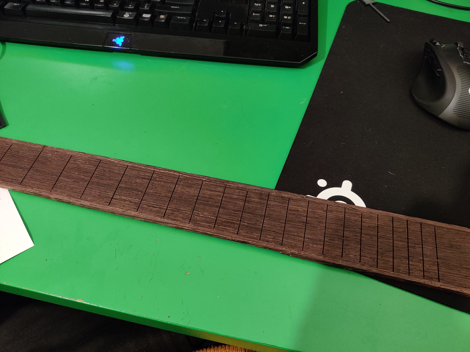 A fretboard with binding glued