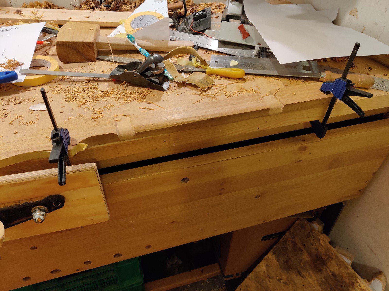 A neck clamped to a workbench with two reference cuts