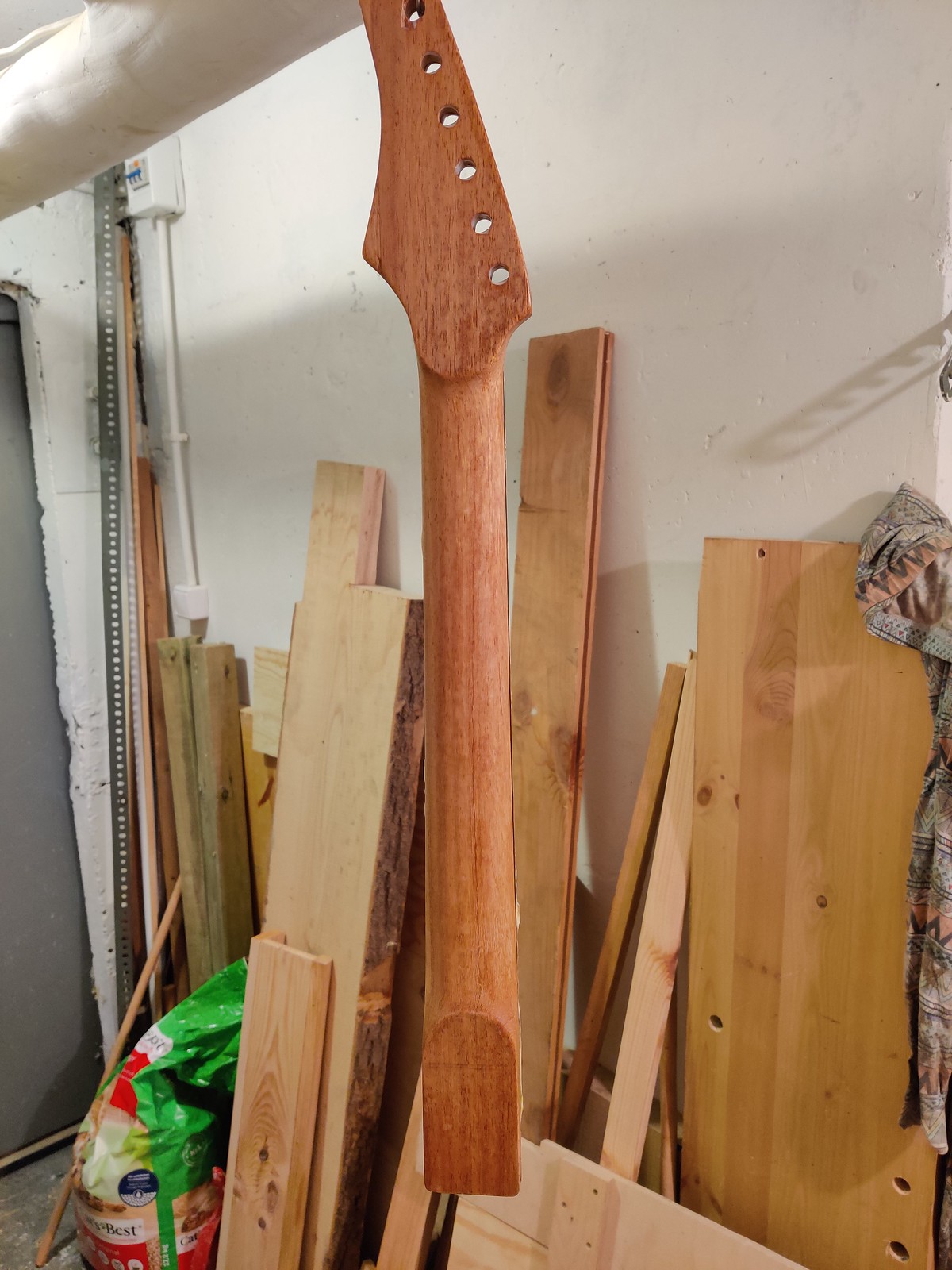 Guitar neck hanging with varnish drying